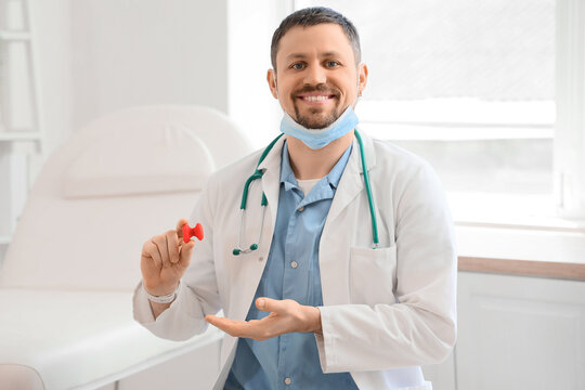 Thyroid health and endocrinology, doctor holding a model of the thyroid gland in a medical clinic for patient education and disease awareness