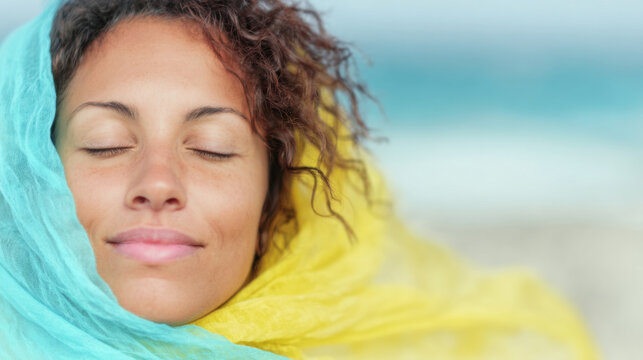 Woman enjoying peaceful moments at the beach with a colorful scarf