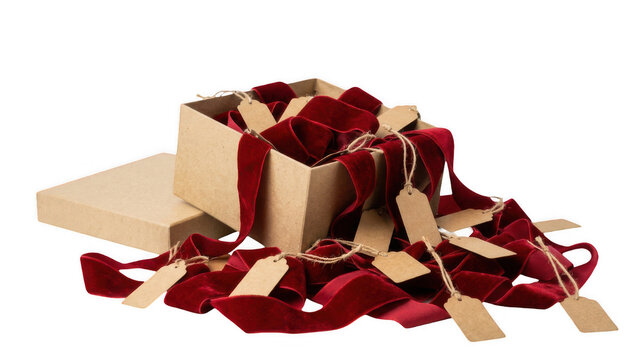 Unboxing red velvet ribbon with blank gift tags for christmas and holiday presents.