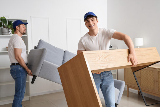 Moving service and relocation assistance, professional movers carrying furniture into a new home for residential relocation and house moving project