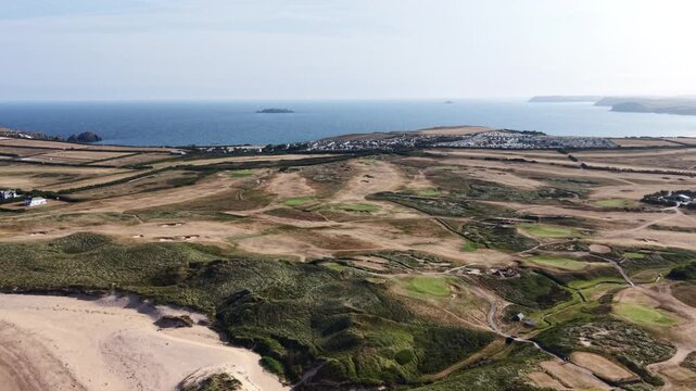 Constantine Bay, England, United Kingdom - 23 July 2026: Aerial view of the coastal golf course with sand dunes and green fairways overlooking the Atlantic Ocean.