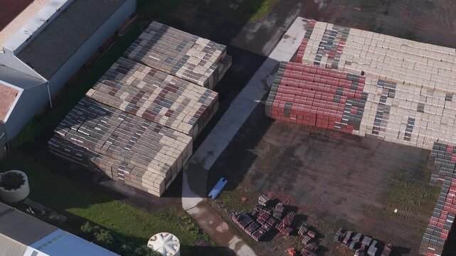 Scoresby, Victoria, Australia - 13 September 2026: Aerial view of PGH Bricks and Pavers Selection Centre showing stacks of bricks and pavers in the yard.