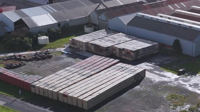 Scoresby, Victoria, Australia - 13 September 2026: Aerial view of PGH Bricks and Pavers Selection Centre with stacked pallets of bricks in the yard.