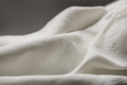 Antique homespun cloth texture background. Cotton fabric texture backdrop natural eco folded linen border over grey. Bio textile material backdrop, canvas top view, close up. 