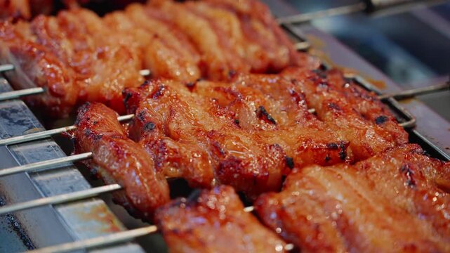 Lusty barbecued pork is being grilled on the grill at the night market