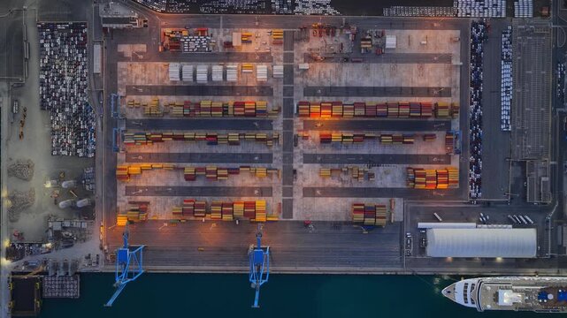 Aerial view of the Civitavecchia Port featuring rows of shipping containers and a cruise ship docked at the pier in Civitavecchia, Lazio, Italy.