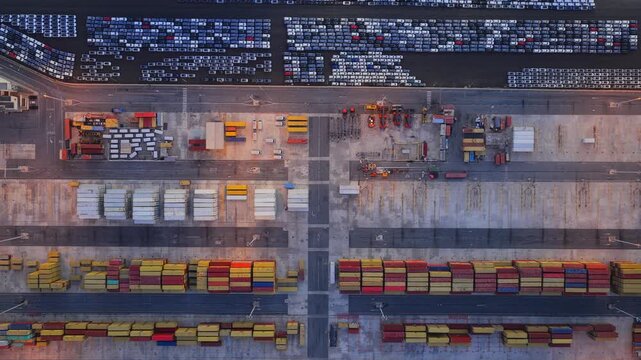Aerial view of Civitavecchia Port with rows of colorful shipping containers and parked vehicles in Civitavecchia, Lazio, Italy.