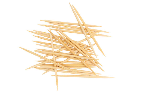 Wooden toothpicks pile scattered on white background
