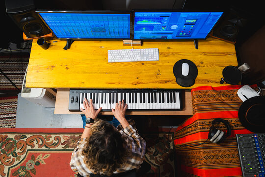 Independent music producer creating music in studio