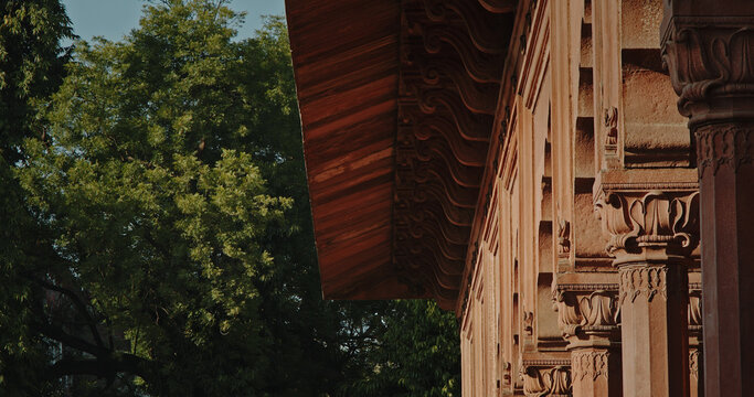 Intricate carved capitals and red sandstone details of Red Fort colonnade architecture
