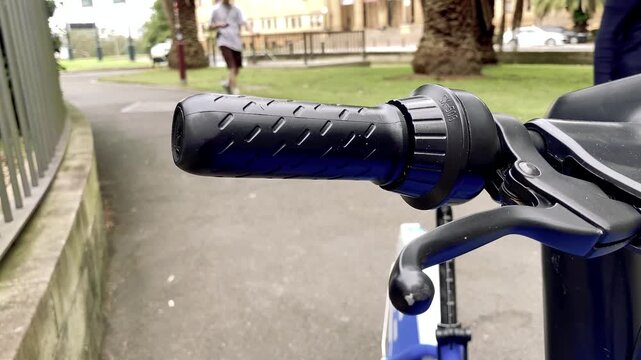 Close View of an Electric Scooter Handlebar in a Park