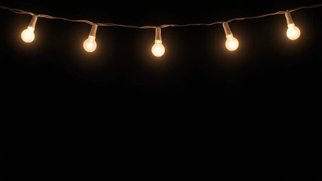 Warm white LED fairy lights string on black background, glowing light bulbs hanging on thin wire, festive Christmas decoration overlay with copy space