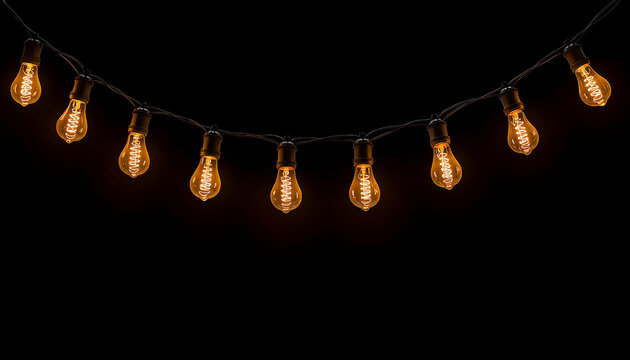 Warm glowing Edison string lights hanging in the dark