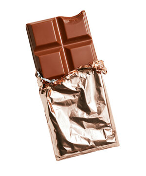 Milk chocolate bar with a bite mark in gold foil isolated on transparent