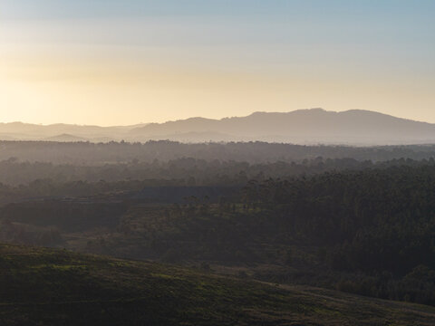 bright hazy sky above layered hills &ndash; air quality in mining town