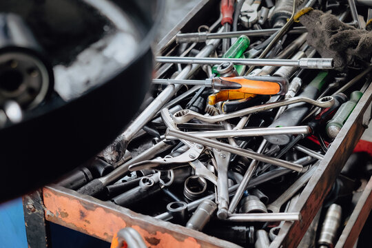 Assorted mechanic tools are ready for use in a full metal toolbox, useful for repair work
