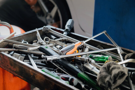 Assorted mechanic tools are ready for use in a full metal toolbox, useful for repair work
