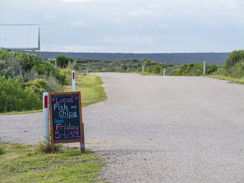 Fish and chip sign by side of quiet street