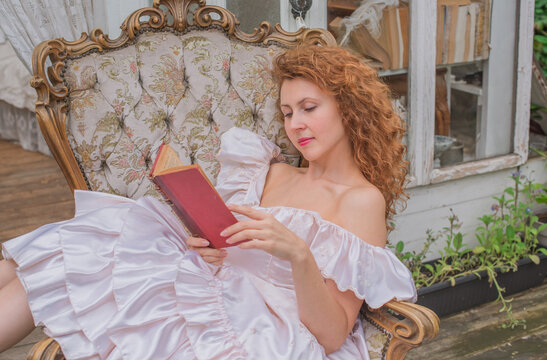 Romantic Victorian Woman Reading an Old Book. Perfect for concepts of reading, women&rsquo;s fiction, classic literature, imagination and book lovers