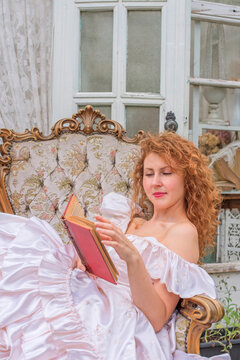 Romantic Victorian Woman Reading an Old Book. Perfect for concepts of reading, women&rsquo;s fiction, classic literature, imagination and book lovers