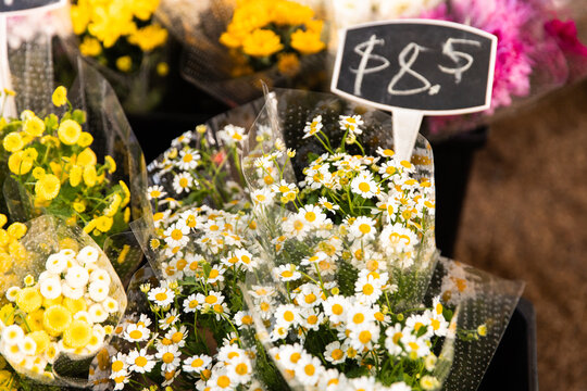 Bright bunches of fresh flowers are displayed at a market stall
