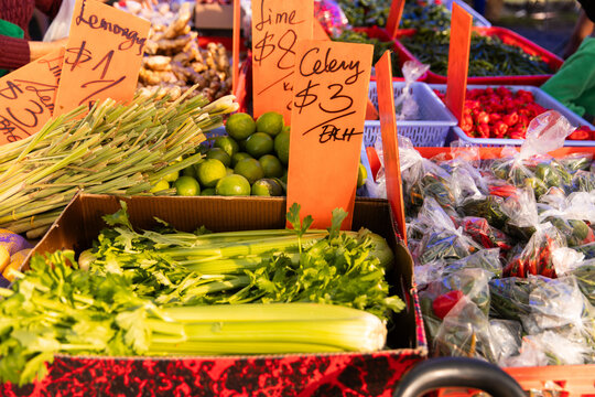 Vibrant farmers market scene filled with fresh produce and handwritten price signs