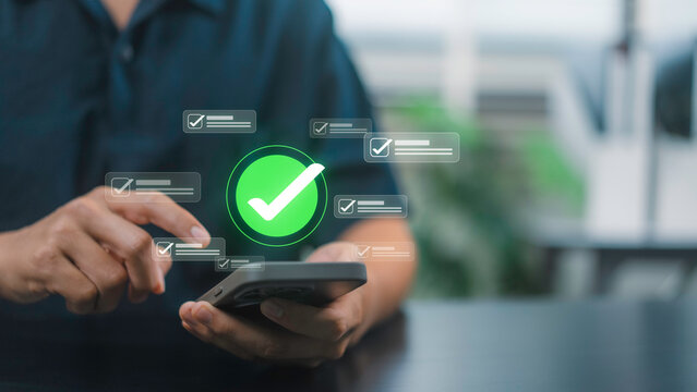 Mobile checklist concept with business professional using smartphone to review completed tasks, confirm digital workflow status, verify process steps, and support mobile workplace productivity