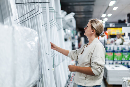 Woman Examining Panels in Home Improvement Store