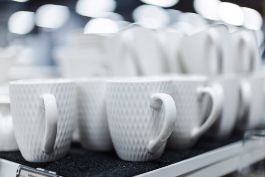 Close-Up of Textured White Ceramic Mugs on a Retail Shelf