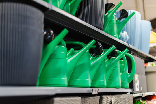 Green Plastic Watering Cans on Retail Store Shelf