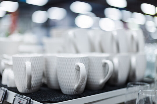 Close-Up of Textured White Mugs on a Retail Shelf