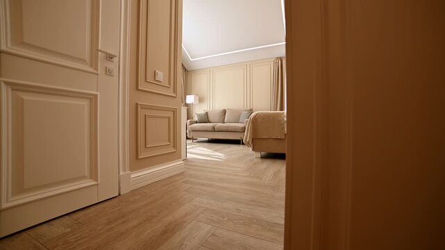 Tracking shot through a modern hallway into a room