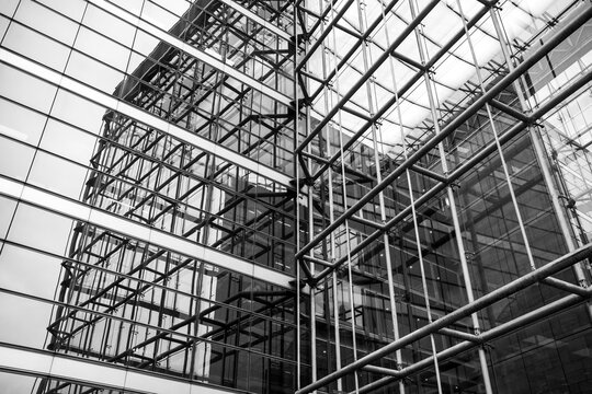 Steel and glass architecture forming an abstract geometric structure in Paris photographed in monochrome with intersecting lines filling the frame