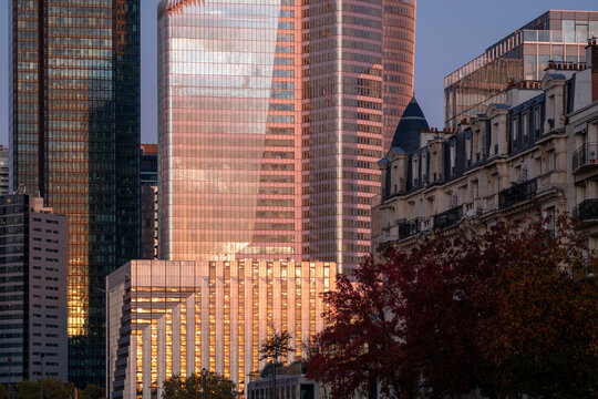 Glass towers in Paris photographed in evening light with modern architecture and low rise buildings as the glass towers rise across the cityscape