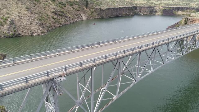Truss bridge spans tranquil reservoir