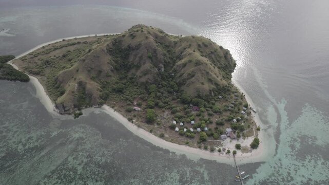 Aerial View of Kanawa Island Labuan Bajo, Flores with Hilly Landscape Village and Coral Reefs