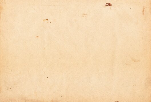 Aged, beige paper with uneven discoloration and scattered dark spots, conveying a nostalgic vintage feel suitable for backgrounds and creative projects