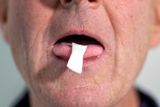Stockholm, Sweden A man places a smokeless and tobacco-free nicotine pouch or snus on his tongue.