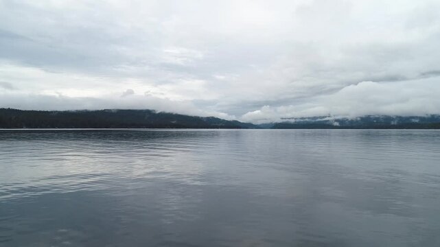 Overcast sky mirrors in still lake waters