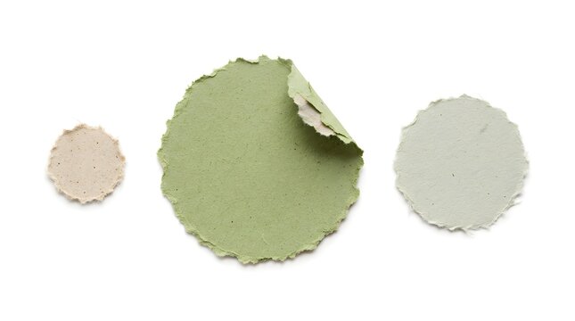 Green and beige circular handmade paper labels with deckle edges for eco friendly branding use.
