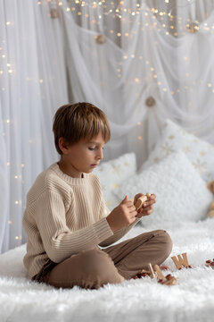 Happy child on Christmas, enjoying some quality time, opening presents, kids on Christmas eve in decorated home