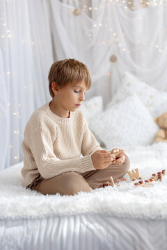 Happy child on Christmas, enjoying some quality time, opening presents, kids on Christmas eve in decorated home