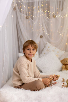 Happy child on Christmas, enjoying some quality time, opening presents, kids on Christmas eve in decorated home