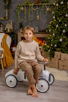 Happy child on Christmas, enjoying some quality time, opening presents, kids on Christmas eve in decorated home