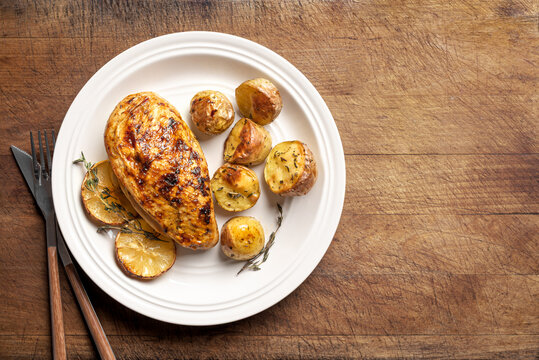 Oven roasted lemon garlic chicken and potatoes on plate