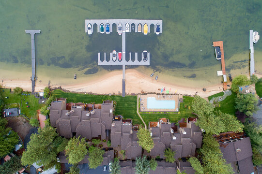 Top-down shot shows holiday cabins, boat slips, and tranquil shoreline