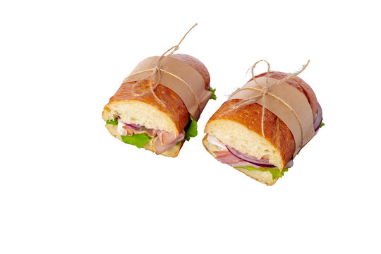 Two sandwiches wrapped with paper string ready to be served