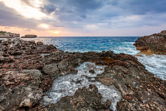 Rough coastal rocks and waves in Cala d'Or, Mallorca, Spain.