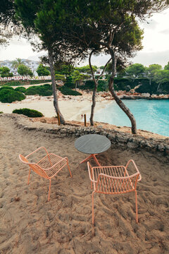 Beach chairs on sand at Cala Esmeralda, Mallorca, Spain.