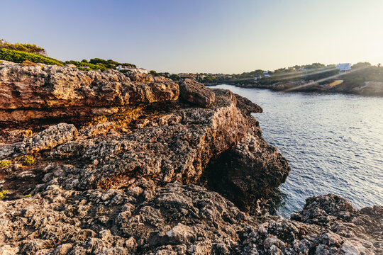 Rugged coastal rocks in scenic Cala d'Or, Mallorca, Spain.